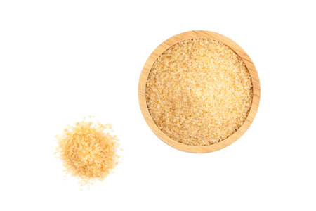 top view angle of raw organic cane sugar, brown sugar in wooden bowl isolated on white backgroundの写真素材