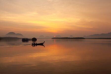 Coloful landscape of sunrise with longtail boat at Sam Chong Tai, Takuathung, Phang Nga, southern of Thailandの写真素材