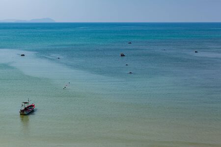 fishing boat moored to the shore waiting time for fishingの写真素材