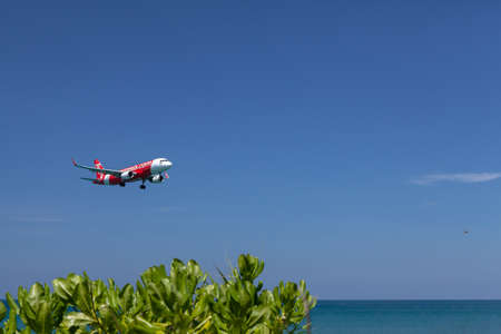 Phuket - Thailand; February 16, 2019: AirAsia is a Malaysian low-cost airline landing to Phuket international airport near Mai Khao beachのeditorial素材