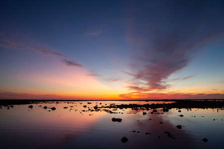 Silhouette of the woman raise her hand in the evening at Pakarang beach, Phang Nga, Thailandの写真素材