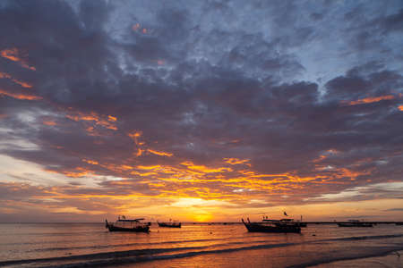 Silhouette of the woman raise her hand in the evening at Pakarang beach, Phang Nga, Thailandの写真素材
