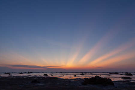 Silhouette of the woman raise her hand in the evening at Pakarang beach, Phang Nga, Thailandの写真素材