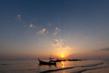 Lanscape of longtail boat in evening time with sunray beam at the beach, Phang Nga, Thailandの写真素材