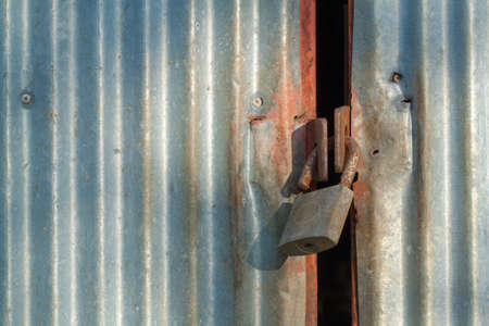 Key unlock on corrugated iron door (security concept)の写真素材