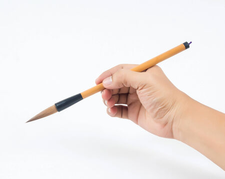 man hand and brown brush on white backgroundの写真素材
