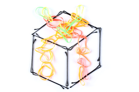 creative gift box made by hair clips and colorful rubber bands on white background