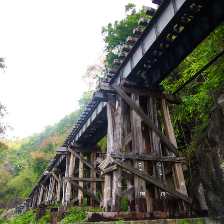 old wood structure of dead railways bridge important landmark and destination of world war II history in kanchanaburi thailand and now is famous visiting point of visitor in thailandの写真素材