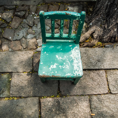old grunge small green wooden chair in the villageの写真素材