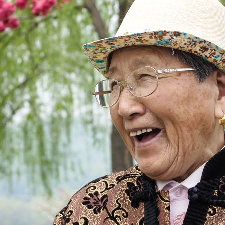 HANGZHOU, CHINA - April 13, 2011 : View in the mist of Xihu, the west lake in hangzhou china, this is image of  old woman wearing a hat and glasses, smiling brightly.のeditorial素材