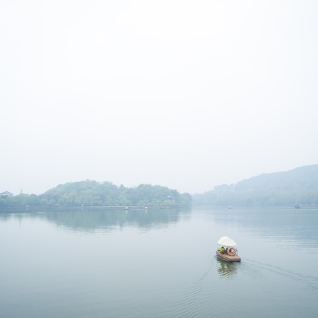 HANGZHOU, CHINA - April 13, 2011 : View in the mist of Xihu, the west lake in hangzhou china, Cruise in the Lakeのeditorial素材
