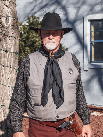 NEVADA, UNITED STATES - April 3, 2012 : A man in cowboy outfit with hat and gunのeditorial素材