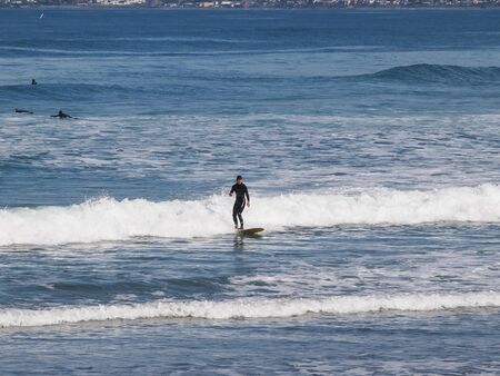 CALIFORNIA, UNITED STATES - April 11, 2012 : Surfing on the wave at Morro Rock Bay, California USAのeditorial素材