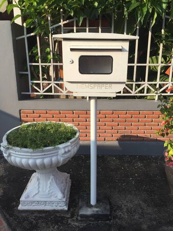 A mailbox in front of the house at the gateの素材