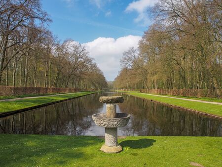 Stone fountain by the beautiful pond in the park of Kasteel De Haar, The Natherlandsの写真素材