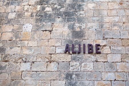 the inscription on an ancient stone wall of Santa Barbara castle. Alicante, Spain.の写真素材