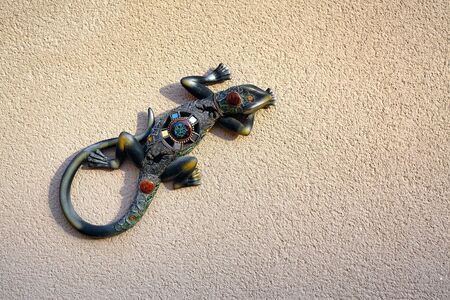 Bright decorative model lizard crawling up the wall. Spainの写真素材