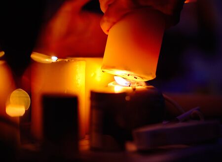 Lights a candle from anotherの写真素材