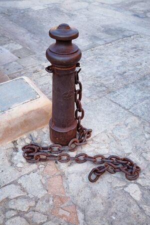 Iron post with chain in the Santa Barbara castle, Albcante, Spainの写真素材