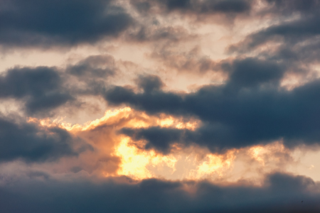 Celestial Battle. Cloud in the form of a crocodile absorbs light at sunset enemy.の写真素材