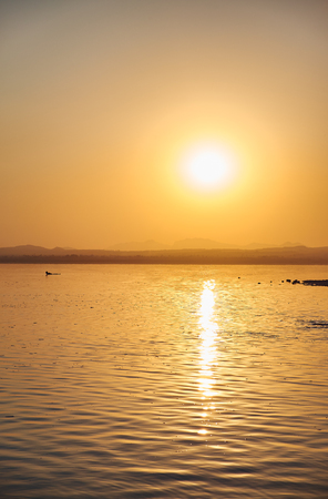 View of the salt lake with a beautiful pink water. Sunset orange sun, the neighborhood.Las salinas, Torrevieja, Spainの写真素材