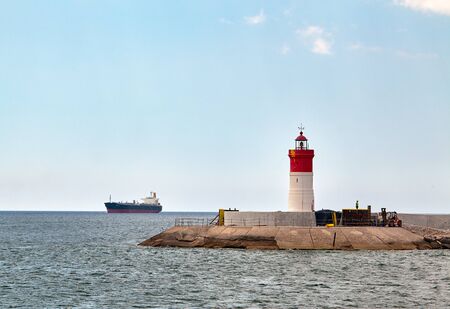 Red and white lighthouse near the fort of Christmas and the seaport. Cartagena, Spain.の写真素材