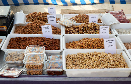Many bags of various types of nuts for sale at Sunday market in Spain, Mercadillo de Campo de...