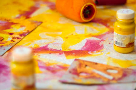 A closeup of artistic instruments, paints, paint roller and paper. The concept of creativity and fantasy development.の写真素材