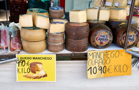El Raso, Alicante, Spain - July 2, 2016: Different cheese in packs and in bulk on market counter, Mercadillo de Campo de Guardamar.のeditorial素材
