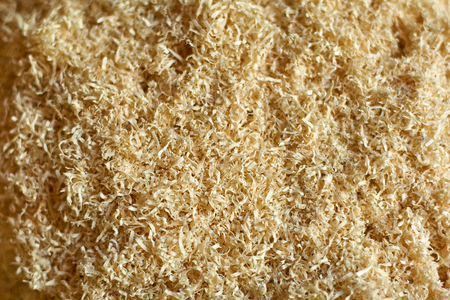 An abstract wood chip background light yellow, sharp at the center and soft at the edges.の写真素材