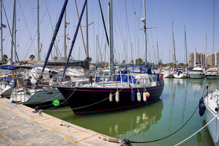 Boat and yacht on a bright sunny day in the seaport of Marina de las Dunas, Guardamar del Segura,...