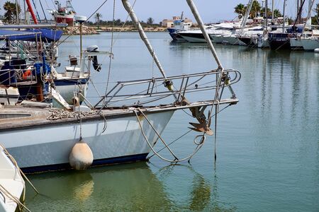 Boat and yacht on a bright sunny day in the seaport of Marina de las Dunas, Guardamar del Segura, Alicante, Spain.の写真素材