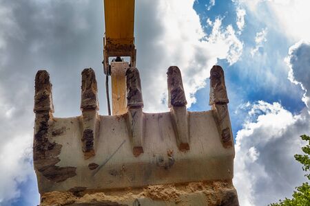 Excavator bucket with large teeth against the sky with clouds and clouds.の写真素材