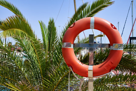 Lifebuoy in the marina for yachts. Red circle in the seaport of Marina de las Dunas, Guardamar del Segura, Alicante, Spain.の写真素材