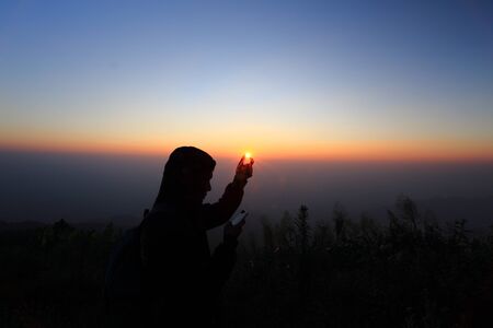 man catch The Sun pose の写真素材