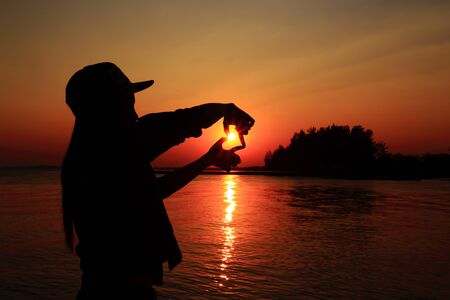 Woman in Sea Sunsetの写真素材