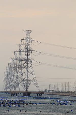 High voltage power pole in the seaの写真素材