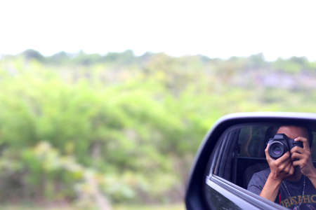 Man in picture from the car on the roadの写真素材