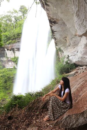 Woman and waterfallの写真素材