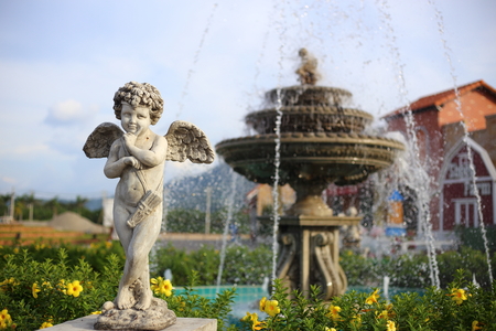 Baby Angel sculpture with a fountainの写真素材