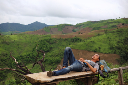 Man sleep on the point of view of the mountains at Nan, Thailandの写真素材