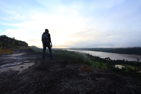 Man standing view mountains of Pha Taem National Park at Ubon Ratchathani, Thailandの写真素材
