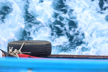 tire and Water waves behind the boatの写真素材
