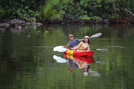 Men and women are kayaking in the canalの写真素材