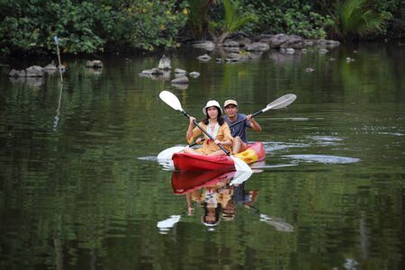 Men and women are kayaking in the canalの写真素材