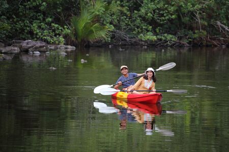 Men and women are kayaking in the canalの写真素材