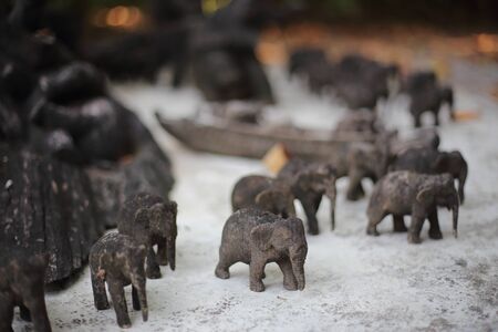 A group of small elephants carved from woodの写真素材