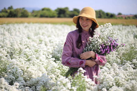 Woman holding flowers in Cutter flower fields at Mae Rim district, Chiang Mai, Thailand.