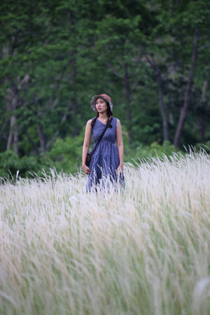 A woman standing in grass color white, Thailand