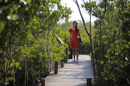 A woman standing at Tung Prong Thong at Rayong, Thailandの写真素材